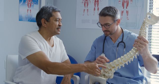 Senior Man Discussing Spine Health with Male Orthopedic Doctor - Download Free Stock Images Pikwizard.com