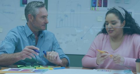 Multiracial Team Discussing Digital Innovation with Smartphones