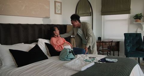 Couple Preparing on Bed for Romantic Celebration Day