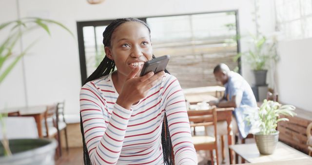 Woman Using Smartphone for Voice Message in Cafe - Download Free Stock Images Pikwizard.com