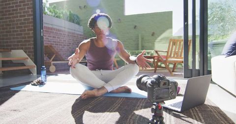 Man Practicing Yoga and Filming Fitness Vlog in Sunlit Living Room