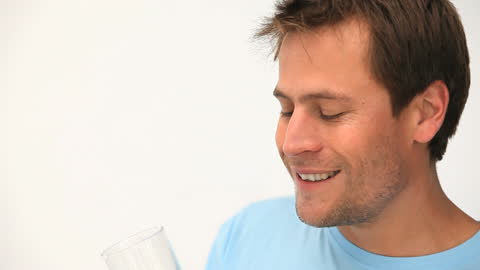 Man Enjoying Fresh Orange Juice in Bright Ambiance