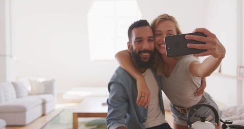 Happy Couple Taking Selfie in Sunny Living Room