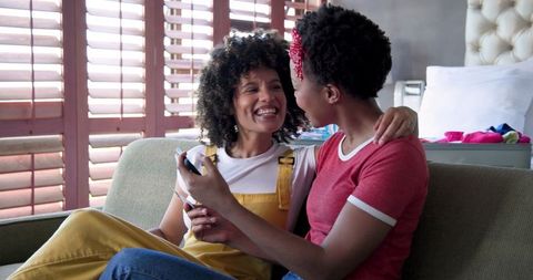 Happy Couple Conversing in Sunny Living Room