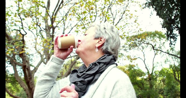 Elderly Woman Enjoying Coffee Outdoors on a Sunny Day - Download Free Stock Images Pikwizard.com