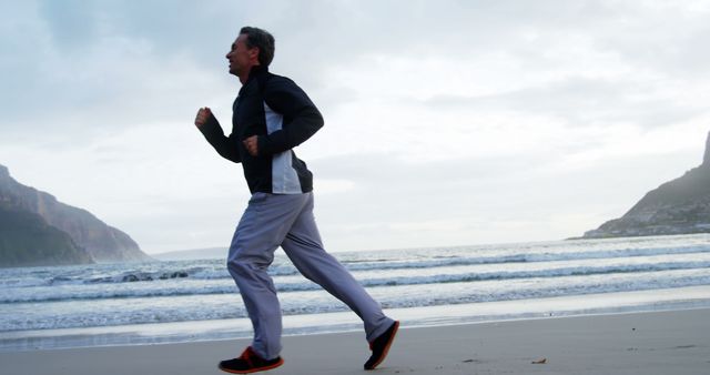 Man jogging on beach during morning - Download Free Stock Images Pikwizard.com
