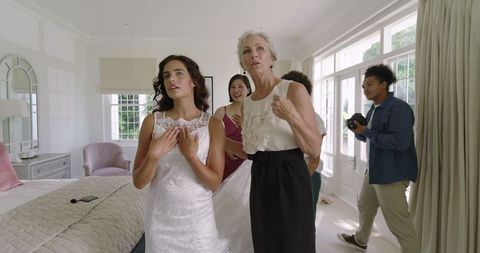 Joyous Bride Embracing Mother in Bright Wedding Room