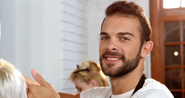 Smiling Male Hairdresser Styling Customer's Hair in Modern Salon - Download Free Stock Images Pikwizard.com