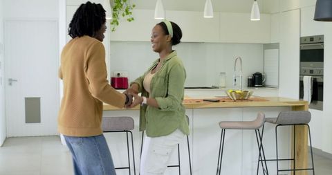African American Couple Holding Hands, Laughing at Modern Kitchen Island, Bright Minimal
