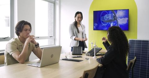Diverse team discussing renewable energy in modern meeting room