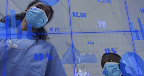 Masked nurses checking monitors with blue data overlays, clinical team collaborating on care