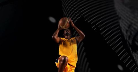 Leaping basketball player executing jump shot amid neon led dots and high-contrast studio