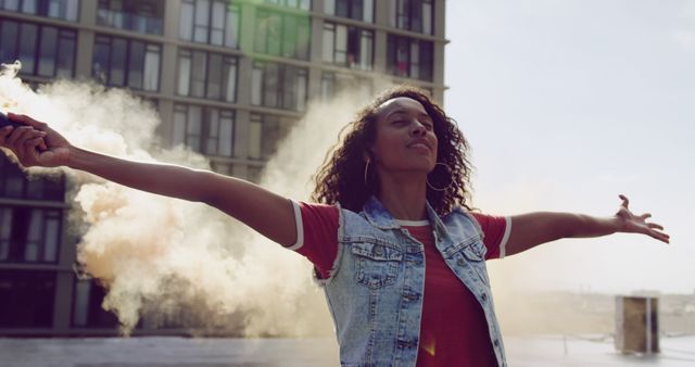 Joyful Woman Celebrating with Smoke Grenade in Urban Setting - Download Free Stock Images Pikwizard.com