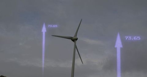 Utility-Scale Wind Turbine Turning with Purple Digital Arrows Showing 73.65 under Overcast Sky