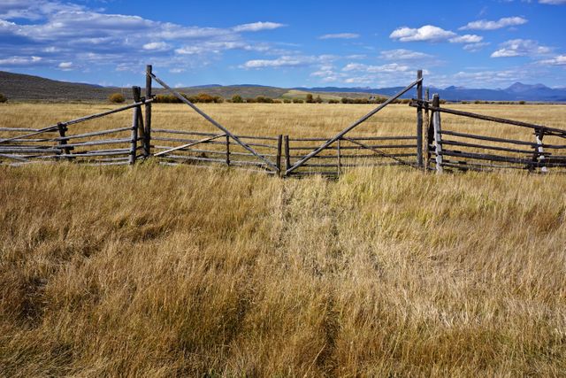 Rustic Wooden Fence in Open Countryside Under Blue Sky - Download Free Stock Photos Pikwizard.com