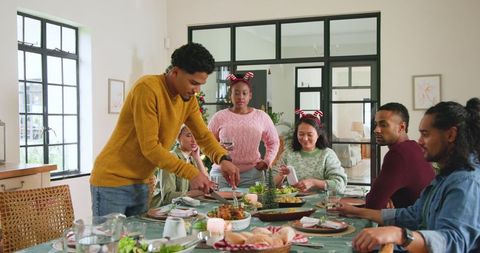 Friends Celebrating With Festive Meal at Home Together