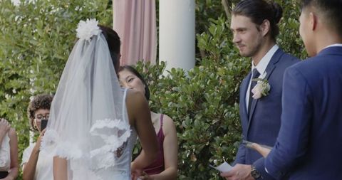 Groom Reading Vows During Outdoor Wedding Ceremony