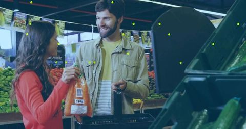 Couple shopping for fresh carrots in grocery store produce aisle