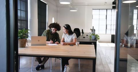 Colleagues Collaborating at Modern Office Table