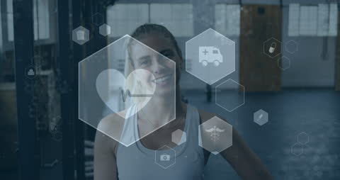 Smiling Woman Exercising Amidst Medical Icons in Gym