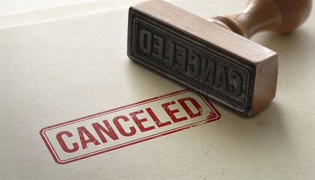 CANCELED Stamp on Cream Paper with Wooden-Handled Rubber Stamp, Closeup Cancellation