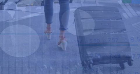 Businesswoman Walking with Suitcase and Global Financial Data Overlay