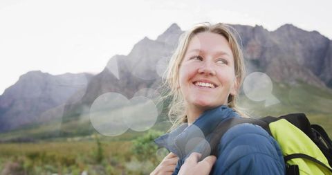 Joyful female hiker admiring mountainous view