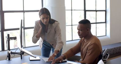 Business Colleagues Collaborating at Office Workspace on Computer