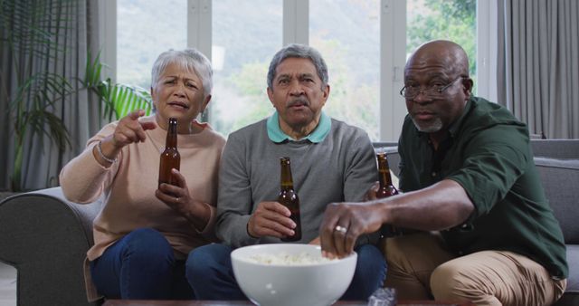 Group of Older Friends Watching TV and Eating Popcorn - Download Free Stock Images Pikwizard.com