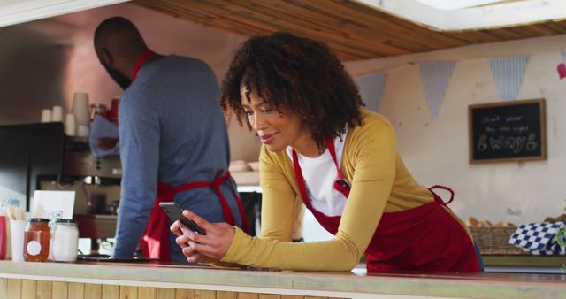 Young African American Woman Using Smartphone in Food Truck - Download Free Stock Images Pikwizard.com