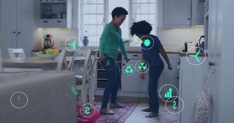 Parent and child dancing in bright kitchen with floating green energy and eco icons