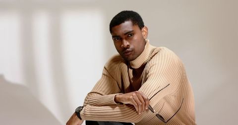 Sophisticated man posing with glasses in modern studio
