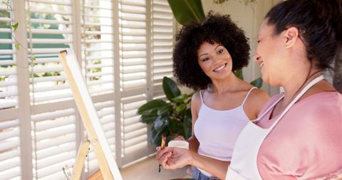 Mother and Daughter Bonding Over Painting Session