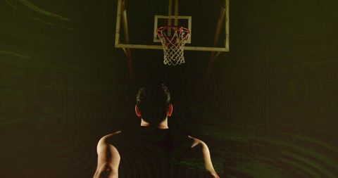Focused Male Athlete Training in Dimly Lit Gymnasium