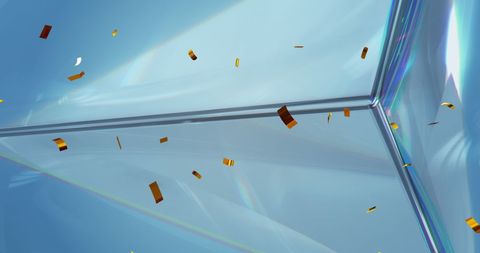 Floating confetti over shimmering crystal background