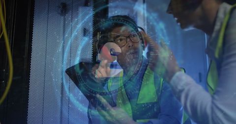 Diverse technicians analyzing digital data in server room