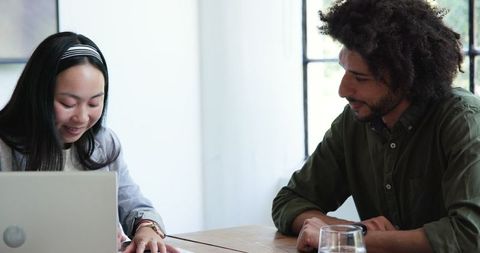 Diverse Business Colleagues Discussing Documents in Modern Office Meeting