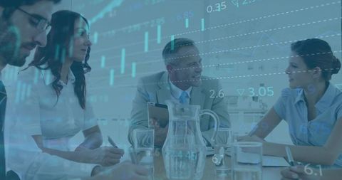 Diverse Business Team Analyzing Data Visualizations at Conference Table