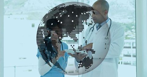 Consulting medical team using tablet with dotted globe overlay for global telemedicine