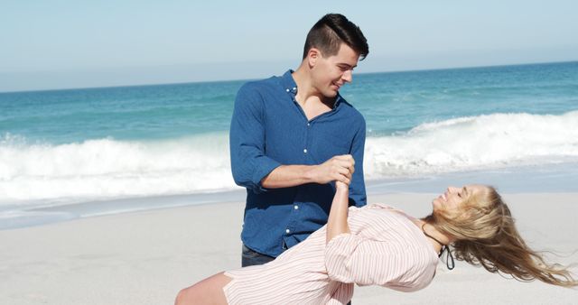 Couple shares a happy and romantic moment on a sunny beach. Perfect for promotions, travel websites, romantic blogs, and advertisements focusing on love and relationships.