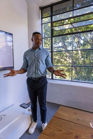 Professional Presenting Data in Modern Office with Natural Light