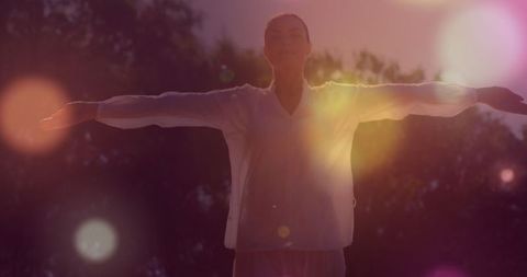 Woman Embracing Peaceful Energy in Meditative Dance Outdoors