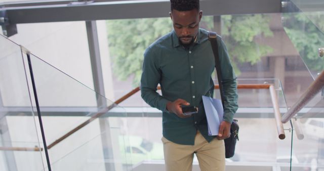 Professional Man Checking Phone While Walking Down Stairs - Download Free Stock Images Pikwizard.com