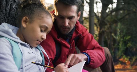 Outdoor Learning Experience: Adult Assisting Child with Homework - Download Free Stock Images Pikwizard.com