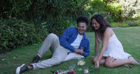 Couple Playing Together in Lush Garden Scene of Joy and Relaxation