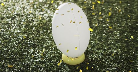 White Rugby Ball on Grass with Celebratory Confetti in Air - Download Free Stock Images Pikwizard.com