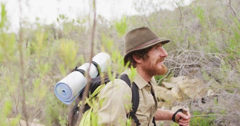 Exploring Hiker with Backpack and Hat in Wilderness Scenery