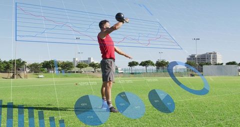 Athlete lifting kettlebell overhead on grass with augmented reality fitness data overlays