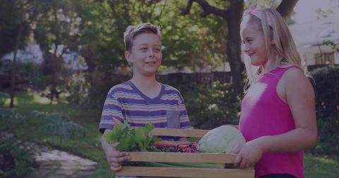 Children carrying vegetables in backyard garden on sunny day