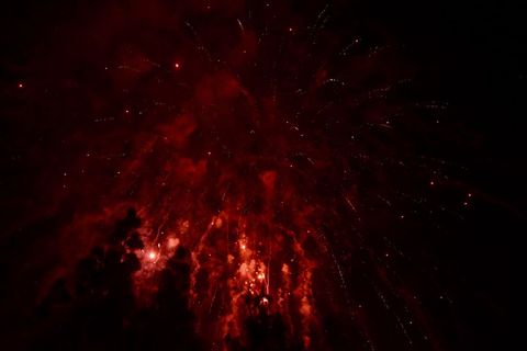 Red fireworks exploding in night sky